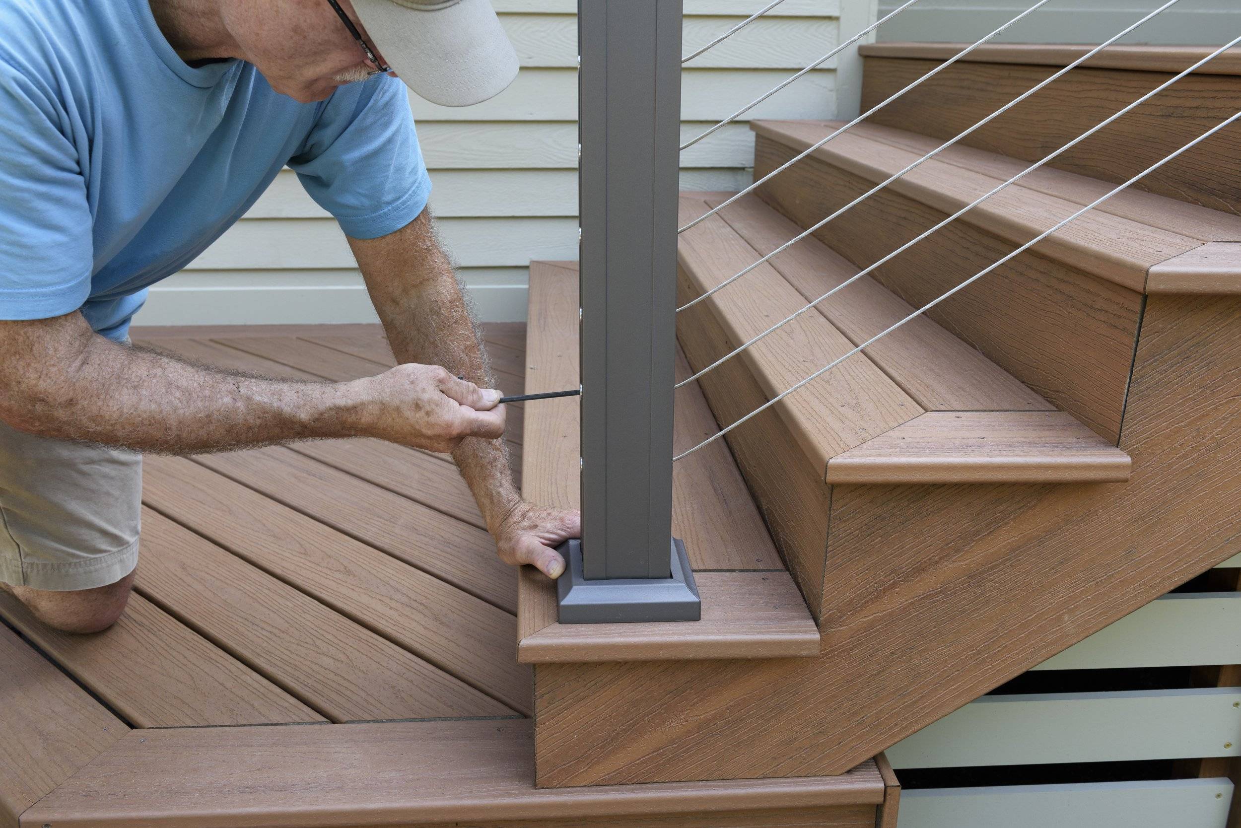 Deck Builder Installing Railing on New Deck